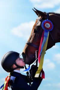 Image of girl thanking her horse